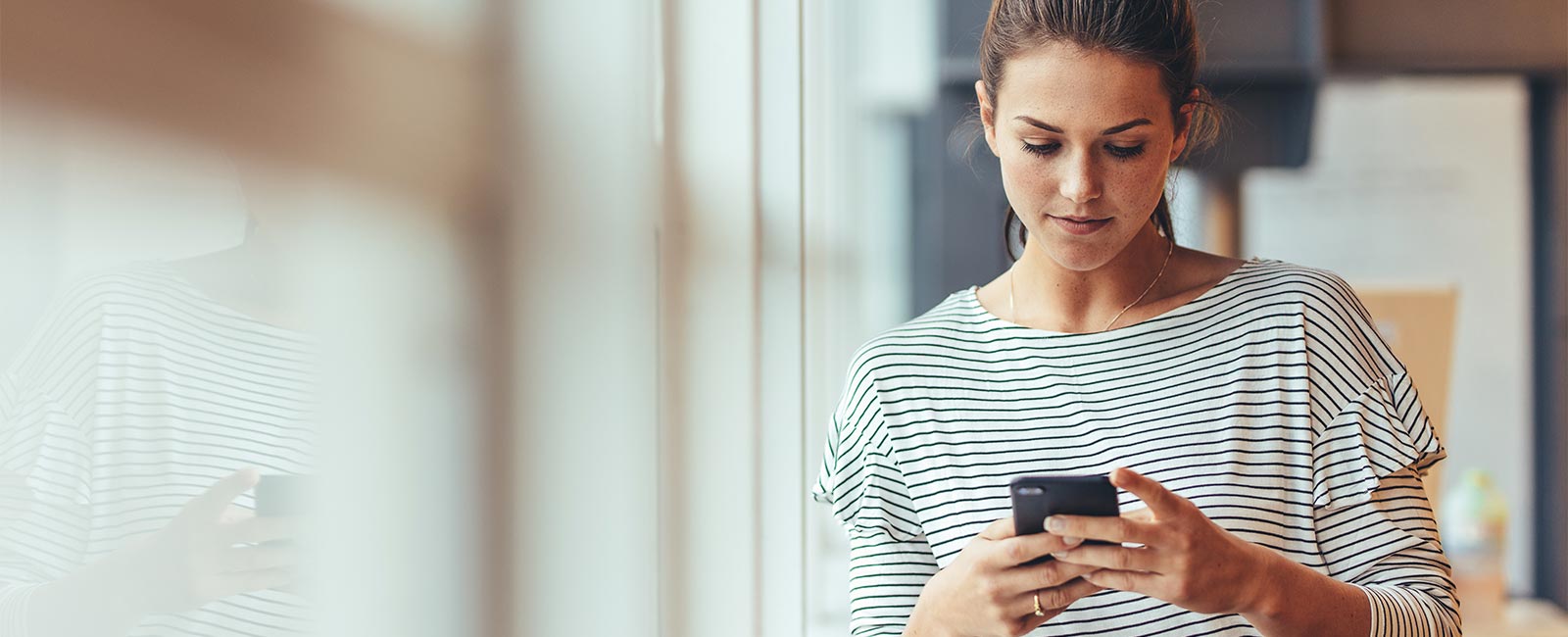 Woman Controlling Home From Phone